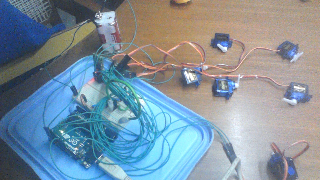 Arduino, breadboard, wires, and servo motors for the braille display